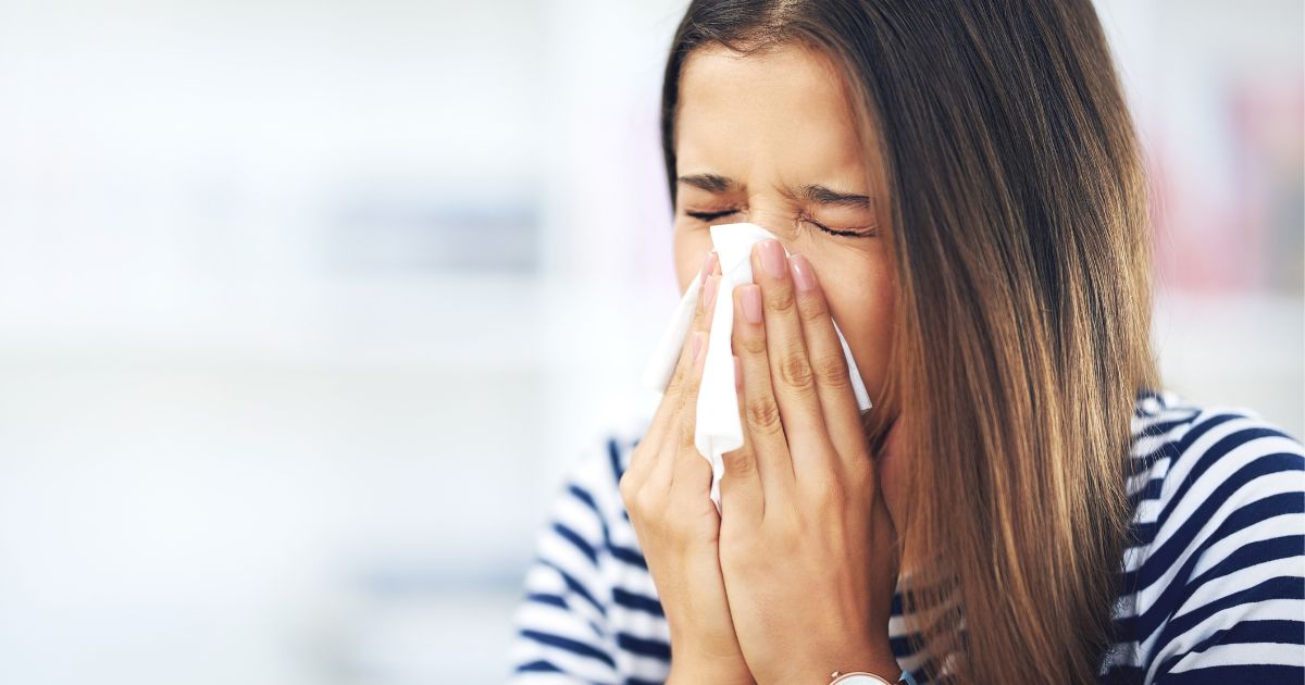 woman blowing nose